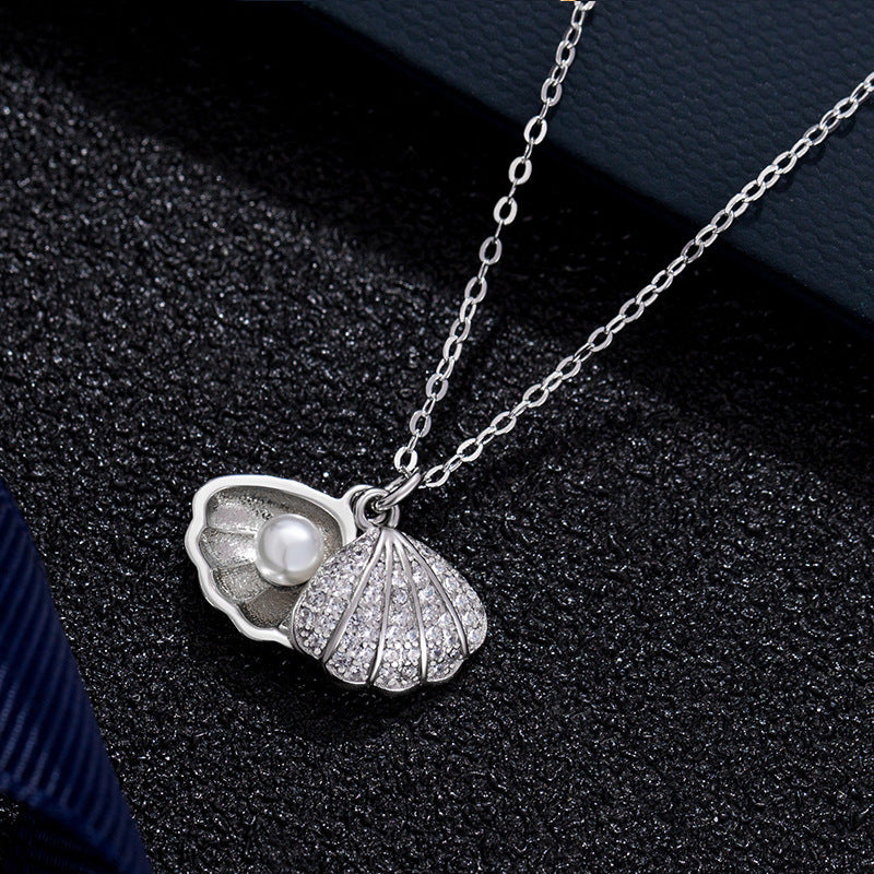 Micropaved zirconia pearl shell necklace